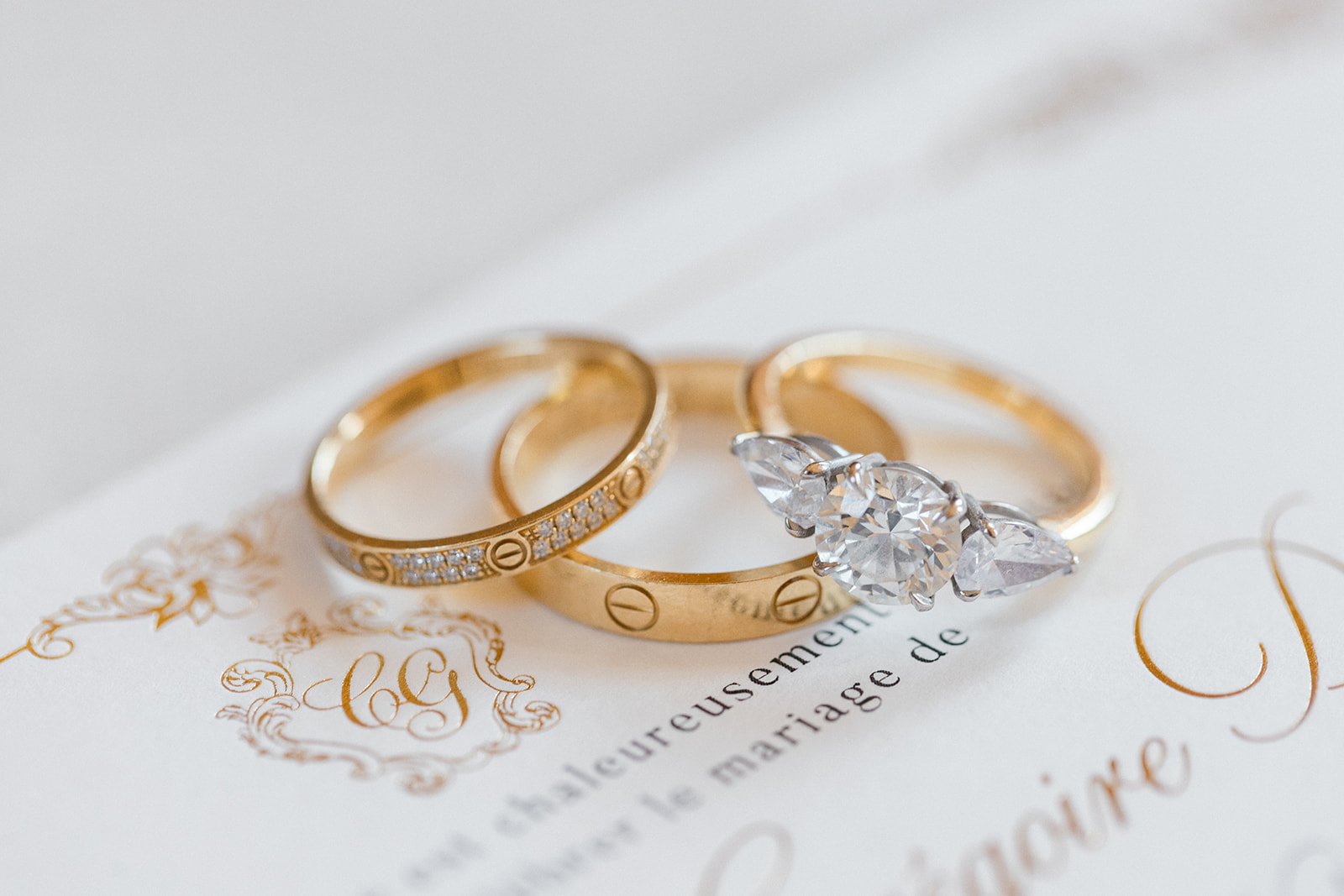 Alliances et bague de fiançailles posées sur un certificat de mariage